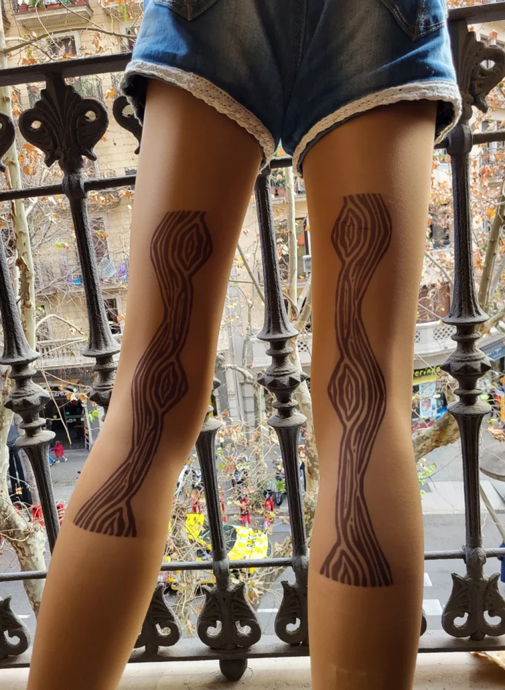 Sheer nude tattoo tights with modern symmetrical line design on the back of the legs, outdoor photo on balcony | Pantimedias nude semitransparentes con diseño moderno simétrico de líneas en la parte trasera de las piernas, foto exterior en balcón