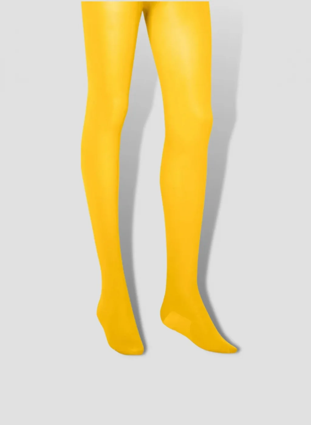 Pantimedias amarillas lisas sobre fondo gris | Yellow opaque tights on gray background
