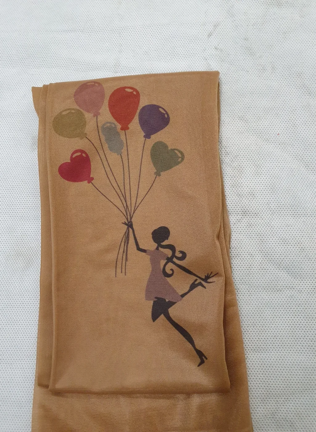 Sheer beige tights with girl flying with colorful balloons print | Pantimedias beige semitransparentes con dibujo de niña volando con globos de colores